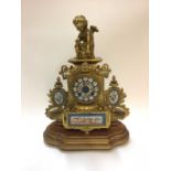 19th century French gilt metal clock with porcelain panels.