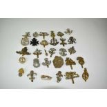 Collection of thirty military cap badges to include The Royal Sussex Regiment, East Surrey Regiment