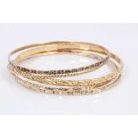 Five gold/yellow metal bangles