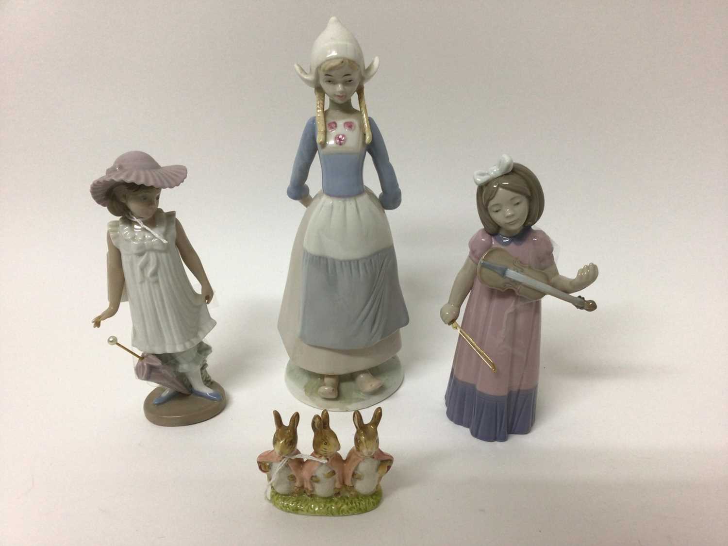 Lladro porcelain figure - girl with lamb, together with six Nao figures another similar figure and