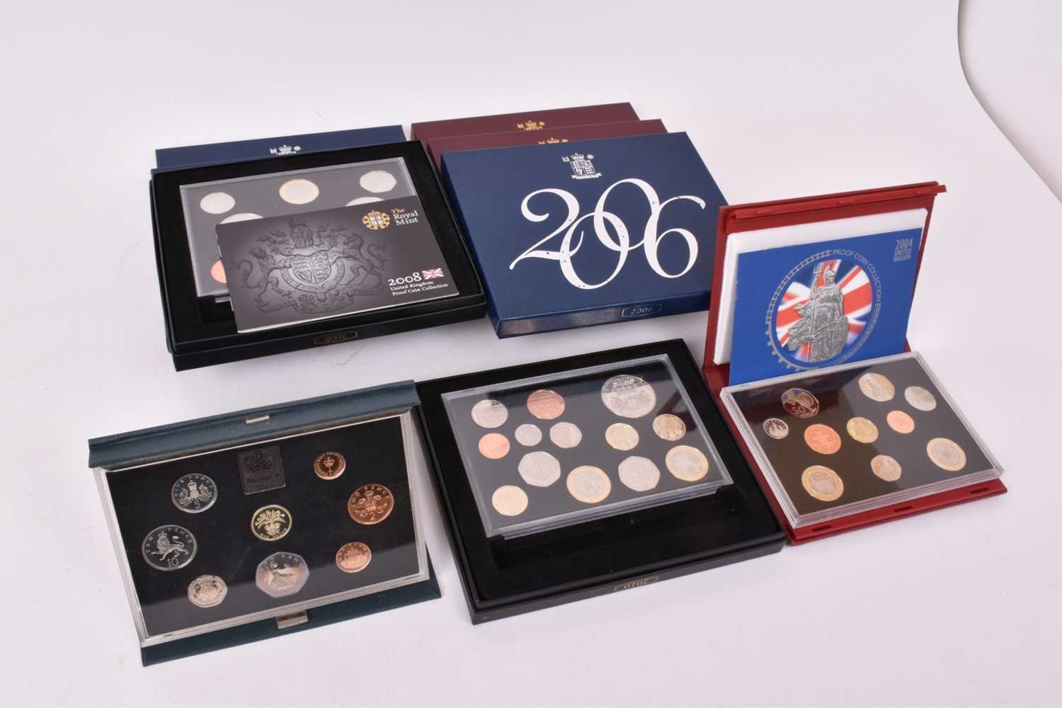 G.B. - Royal Mint proof coin sets to include 1984 (blue case), 2001, 2002, 2003, 2004 (N.B. In red l