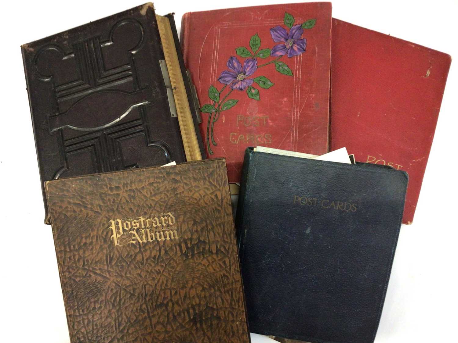 Postcards in five albums plus a large leather Victorian illustrated photograph album. Postcards inc