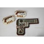 Beadwork holster together with two beadwork purses depicting pistols, manufactured by Syrian Prision