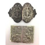 Two Eastern white metal buckles