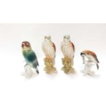 Two Karl Ens porcelain bird ornaments, 14.5cm high and 11cm high, together with two Beswick Kestrels
