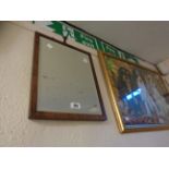 A small mahogany framed bevelled oblong wall mirror