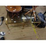 A pair of vintage brassed metal tea tables with smoked glass inset tops and slatted undertiers