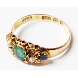 An antique hallmarked 625 (15ct. gold) ring set with three small emeralds interspersed with seed