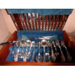 A retro teak effect canteen containing an eight place setting of Oneida silver plated cutlery with