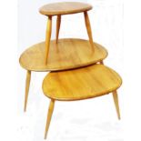 A nest of three Ercol light elm pebble tea tables, set on slender turned supports - no labels