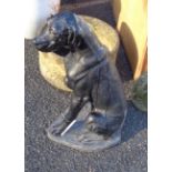 A large concrete garden statue depicting a dog with black painted finish - a/f to plinth base