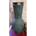A large pottery vase with faux verdigris glaze effect