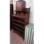 A 93cm early 20th Century Arts and Crafts style stained oak four shelf open bookcase with central