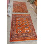 A small rug with repeat central decoration and geometric border - 1.22m X 94cm - sold with a