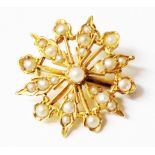 A marked 15ct. yellow metal starburst pattern pendant/brooch, set with seed pearls