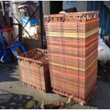 A quantity of fifty stacking plastic shallow apple crates with metal dolly