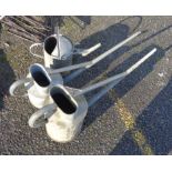 Two long spout galvanised watering cans and another