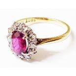 A marked 18ct/PLATINUM ring, set with central oval ruby within a diamond encrusted border - boxed