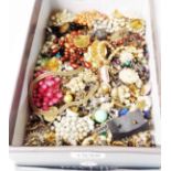 A shoebox containing a quantity of assorted costume jewellery