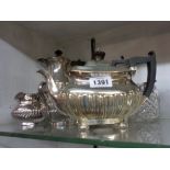 A silver plated harlequin three piece tea set - sold with two semi-reeded hot water jugs and a sugar
