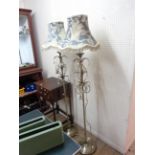 A pair of modern ornate brassed metal standard lamps with crystal glass drops to acanthus