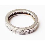 An unmarked white metal diamond set eternity ring