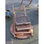 A wooden slatted garden table and two matching chairs
