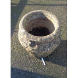 A Cotswold stone concrete garden planter of urn form with stylised chain link decoration
