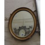 A gilt framed bevelled oval wall mirror - frame a/f