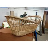 A vintage wicker baby's carrying cot