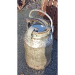 A vintage galvanised steel milk churn with locking cap