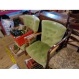 A pair of vintage beech framed boudoir elbow chairs with green velour button back upholstery