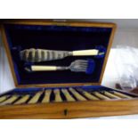 A vintage polished oak cased set of six each silver plated fish knives and forks with servers, all