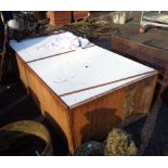 A pair of large shop display wooden stages on casters with formica tops and central hole for