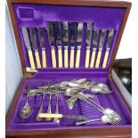 A vintage mahogany canteen containing a quantity of assorted silver plated and other cutlery