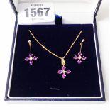 An import marked 375 gold suite of jewellery comprising an amethyst and diamond set pendant on chain