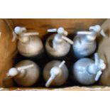 Six vintage soda syphons with later mottled grey paint effect