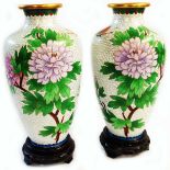 A pair of 20th Century cloisonne vases decorated with large blossoms and insects on a white scale