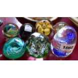Seven decorative glass paperweights including Isle of Wight and Caithness examples