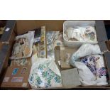 A box containing a large collection of recovered world stamps, loose, on sheets and paper, some