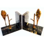 A pair of French Art Deco marble bookends, each set with bronze lovebirds perched upon a branch