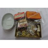 A box containing a small quantity of recovered stamps in vintage tins and on paper, part set of