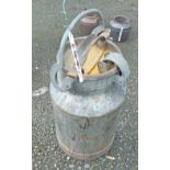 A vintage galvanised steel milk churn with locking cap