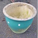 A large green glazed garden planter