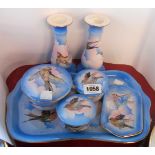 An early 20th Century pottery dressing table set with transfer printed birds on a blue stencil