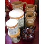 A set of three graduated stoneware jugs - sold with a set of three vintage paisley decorated storage