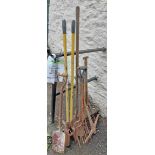 A selection of garden tools including forks, shovels, pickaxe, etc.