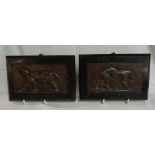 A pair of bronze plaques, each depicting a lioness, marked Barye 1831 - mounted on black marble
