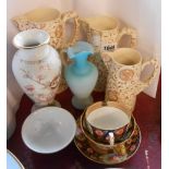 A selection of ceramic items including a set of three graduated brown transfer printed jugs in the