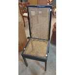 An ebonised framed high back standard chair with rattan panels - wear